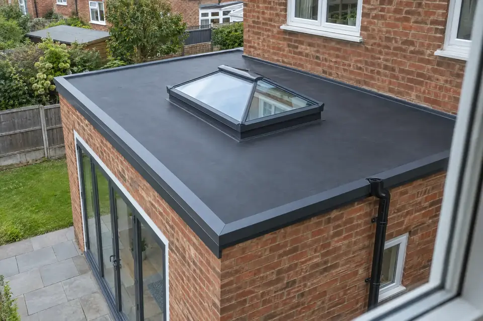 New black EPDM rubber flat roof with aluminium trims and a roof lantern on a rear extension
