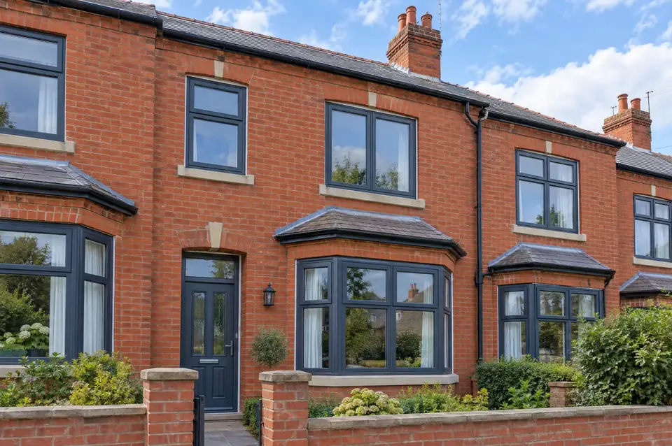 Red-brick terraced house with new anthracite grey uPVC casement windows